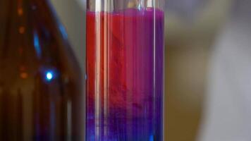 Scientist Pours Blue Pattern Chemicals Into In Flask. health care and medical concept. Scientist are certain activities on experimental science like mixing chemicals video