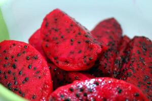 Dragon fruit with black seeds in a bowl. Close-up. photo