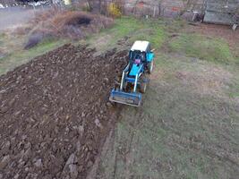 Tractor plowing the garden. Plowing the soil in the garden photo