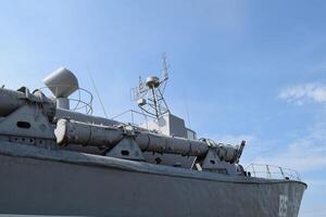 Part of the deck of a warship. communication devices and deck guns. photo