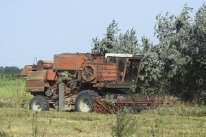 Old rusty combine harvester. photo