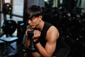 Lifting dumbbell exercises builds strong upper arm muscles. Exercise activities for health lovers and builds a good and strong figure. photo