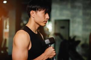 Lifting dumbbell exercises builds strong upper arm muscles. Exercise activities for health lovers and builds a good and strong figure. photo