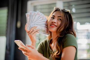 Dollar Currency Finance and Investment Young woman happy with money and wages from work, income, cash flow photo