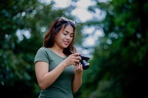 Beautiful Asian tourist and her personal camera female photographer Surround Milleles photo