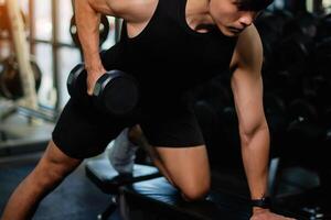 Lifting dumbbell exercises builds strong upper arm muscles. Exercise activities for health lovers and builds a good and strong figure. photo