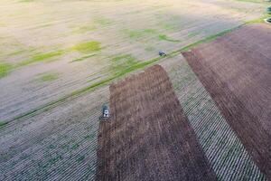 Top view of the tractor that plows the field. disking the soil. Soil cultivation after harvest photo