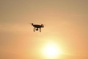 drone silhouette against the background of the sunset photo