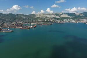 Industrial seaport, top view. Port cranes and cargo ships and barges. photo