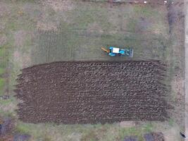Tractor plowing the garden. Plowing the soil in the garden photo