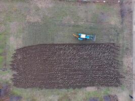 Tractor plowing the garden. Plowing the soil in the garden photo