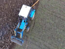 Tractor plowing the garden. Plowing the soil in the garden photo