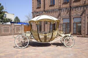 forged carriage on the site near the building. Beautiful decorative coach. photo