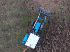 Tractor plowing the garden. Plowing the soil in the garden photo