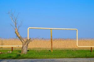 The arch of the gas pipeline above the passage in field. photo