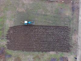 Tractor plowing the garden. Plowing the soil in the garden photo