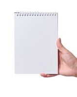 Female hand holding an open notepad on a white isolated background photo