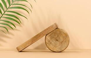 Round brown wooden stand on a beige background, a place to display cosmetics and products photo