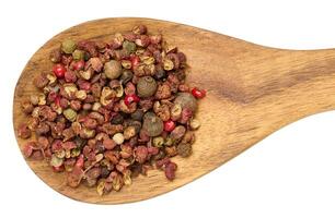 Mixture of red and black peppercorns with wooden spoon on isolated background photo