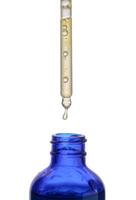 A glass blue bottle with a dropper on a white isolated background photo