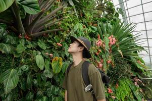 a man in Cloud Forest dome environment at Gardens in Singapore photo