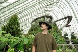 a man in Cloud Forest dome environment at Gardens in Singapore photo