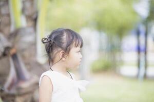 Portrait of a young Asian girl smiling at the camera - Happy Thai girl having fun posing. photo