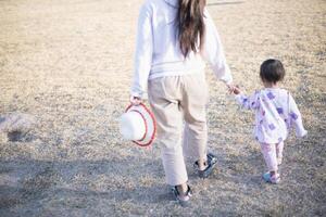 Mother and daughter playing and running around the park on beautiful morning. photo