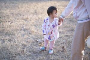 Mother and daughter playing and running around the park on beautiful morning. photo