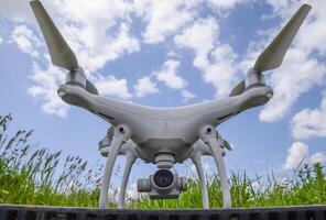 Quadrocopters on a plastic box in the grass photo