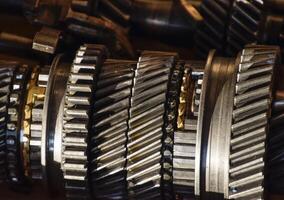 Dismantled box car transmissions. The gears on the shaft of a me photo