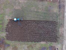 Tractor plowing the garden. Plowing the soil in the garden photo