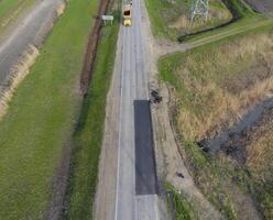 Top view of the road repair. Technics for repair of asphalt. Replacement of asphalt pavement. photo