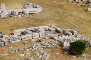 Top view of the excavation site in ruined ancient city of Hierapolis. The remains of destroyed buildings and columns. photo
