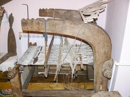 Ancient wooden loom. Ancient textile equipment. photo