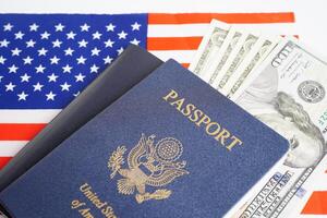 US passport with dollar money on USA flag, American citizen in United States of America. photo