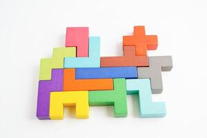 Logical thinking and problem solving problem solution creative business concept, wooden puzzle geometric block shape. photo