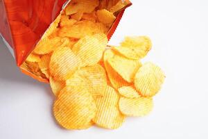 Potato chips in open bag, delicious BBQ seasoning spicy for crips, thin slice deep fried snack fast food. photo