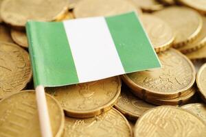 Nigeria flag on coin and banknote money, finance trading investment business currency concept. photo