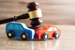 Car accident lawsuit and insurance, Judge hammer with car model. photo