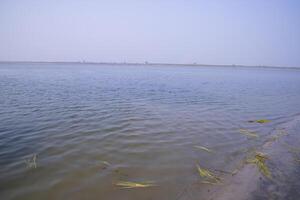 natural paisaje ver de el banco de el padma río con el azul agua foto