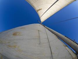 old sails of sailboat view from the bottom with fisheye photo