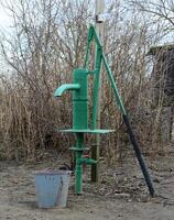 Hand pump leading to an artesian well. photo