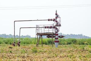 Well for oil and gas production. Oil well wellhead equipment. Oil production photo