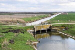 Bridges through irrigation canals. Rice field irrigation system photo