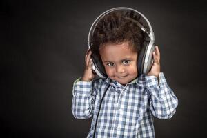 Little boy wears big headphones photo