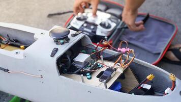 Engineer designing and assembling drones. Homemade aircraft made from resin and carbon fiber photo