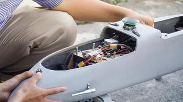 Engineer designing and assembling drones. Homemade aircraft made from resin and carbon fiber photo