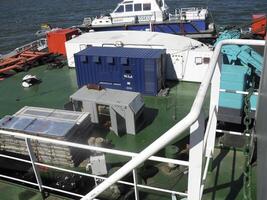 A small boat near the deck of a pipe-lay vessel. photo