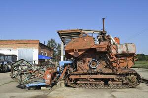 Old rusty disassembled combine harvester. photo